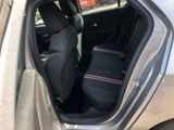 the back seat of a car with two black seats and a red stripe