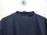 the back of a blue jacket hanging on a hanger