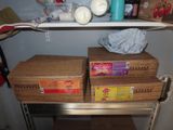 two boxes that are sitting on a shelf in the kitchen