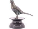 statue of a bird on a pedestal on a white background