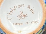 a hand holding a cup with writing on it
