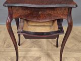 a small table with a drawer on top of it on a wooden floor