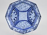 a blue and white plate with a floral design on it