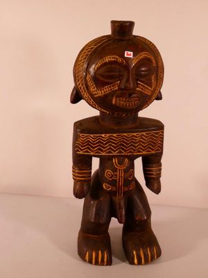 an image of a wooden statue of a man with a hat on