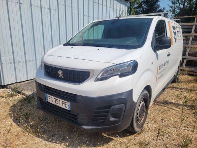 a white van parked in front of a building