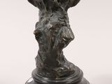 an image of a bronze statue of a woman with a bird on her head