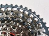 a close up of a bicycle chain and gear on a white surface