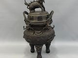 an image of a bronze statue of a dragon on top of a pot