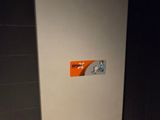 a white toilet with a sticker on it in a bathroom