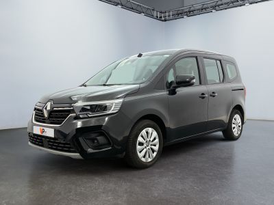 the grey van is parked in a large room