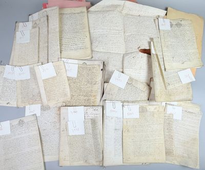 several old papers are piled on top of each other