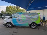 a van that is parked under a blue and green umbrella