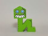 green wooden letter n with a monster face on it