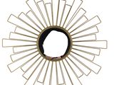 a gold sunburst on a white wall with a person in the middle