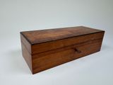 an old wooden box sitting on top of a white surface