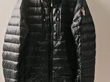 the jacket is hanging on a hanger on the wall