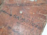 a brown suitcase with writing on it sitting on a table