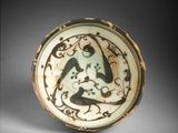 an image of a green and white bowl with a bird on it