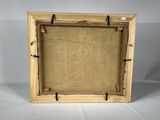 an old picture frame with a piece of burlock on it