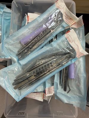 many different types of scissors in a plastic container