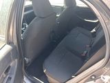 the back seat of a car with a black seat cover