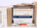 many books stacked on top of each other on a shelf