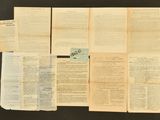 several pages of old papers on a table with a black background