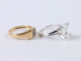 two gold and silver rings, one with a diamond and the other with a diamond