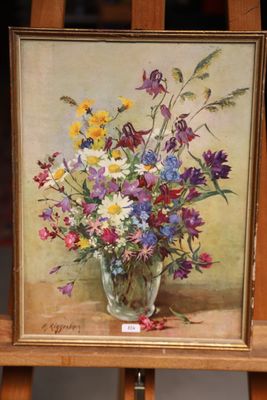 a painting of flowers in a glass vase on a easel