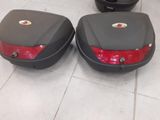 une paire de valises noires et rouges posées sur un sol carrelé