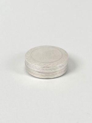 an image of a silver coin sitting on top of a white surface