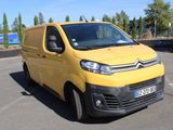 citroen van parked in a parking lot with a trailer in the background