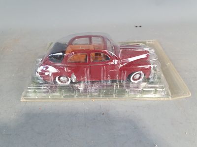 a red toy car sitting on a clear tray
