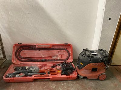 two tools in a case on the floor next to a wall