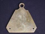 a close up of a metal triangle shaped object on a black surface