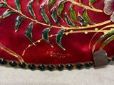 a red purse with a floral design on it