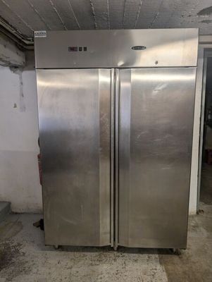 two stainless steel refrigerators that are in a room