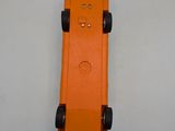 an orange toy car that is sitting on a table