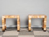 a pair of marble side tables on a checkered floor