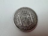 a close up of a coin on a table with a white background