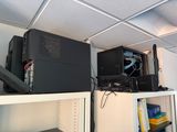 a computer on top of a shelf in a room
