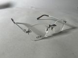 a pair of glasses sitting on a table next to a cell phone