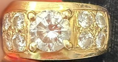a gold ring with three diamonds on it