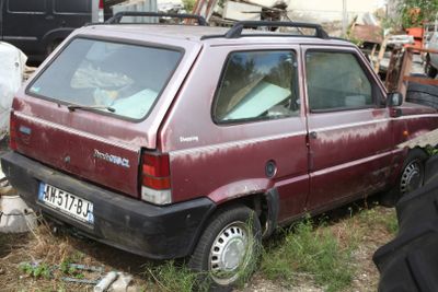 a red car that is parked in the grass
