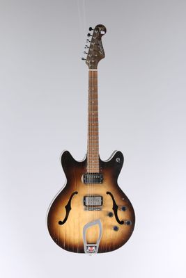 an electric guitar hanging from the ceiling