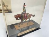 a miniature model of a man on a horse in a glass case