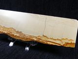a large slab of yellow quartz on a black background