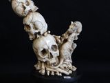 a sculpture of three skulls sitting on top of each other