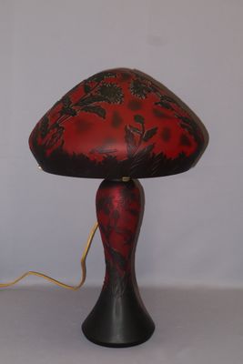 a red and black lamp that is on a table