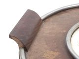 a close up of a clock on a wooden table